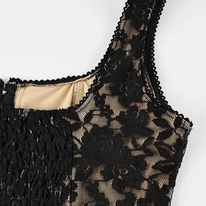 Close-up detail of black floral lace tank top with nude lining and pleated texture