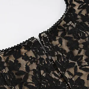 Detail of black lace camisole showing intricate floral patterns and hook closures