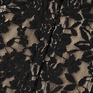 Detail macro view of exquisite black floral lace texture with hook-and-eye closure