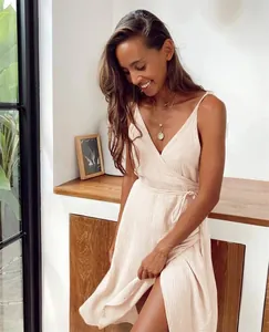 Close-up detail of a pink V-neck crinkle gauze wrap dress featuring a side slit