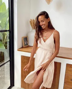 Elegant pink V-neck crinkle cotton wrap dress featuring a stylish side slit and light texture