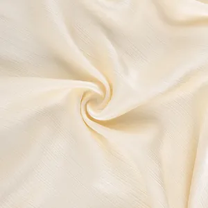 Macro-opname van beige Franse bubbelstof met fijne golvende textuur voor damesbroeken
