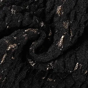 Macro detail of high-quality black and gold floral lace material for elegant camisole