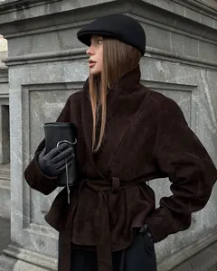 Close-up of a retro brown faux suede jacket with a matching belt and elegant styling
