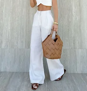 Detail of stylish high-waisted white wide-leg trousers for casual summer chic style.