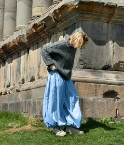 Fashionable light blue women's balloon pants paired with a stylish grey fuzzy sweater
