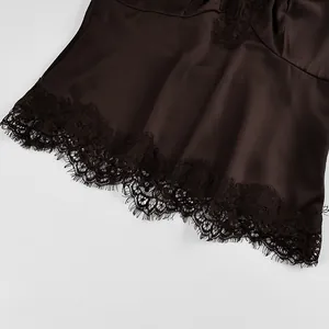 Close-up detail of dark brown satin top featuring delicate eyelash lace trim at hemline.
