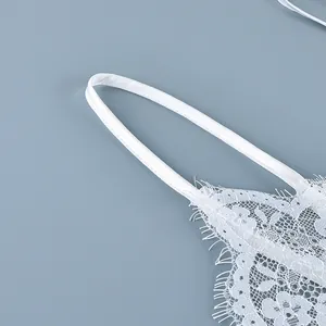 Macro view of white floral eyelash lace camisole with smooth satin shoulder strap