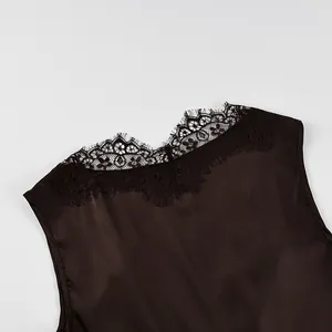 Close-up detail of V-neckline with delicate eyelash lace on dark brown satin top