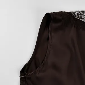 Close-up of brown satin top with delicate black lace trim and side invisible zipper