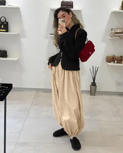 Trendy beige balloon pants with elasticated ankles in a boutique mirror selfie.