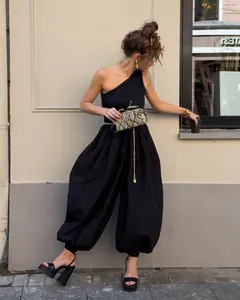 Elegant female model showcasing a black one-shoulder wide-leg balloon pants jumpsuit