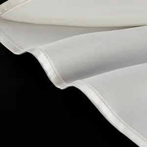 Detail shot showing the smooth texture and neat hem of a white satin camisole top