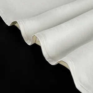 Close-up detail of the white satin fabric and hem stitching on a lace V-neck camisole