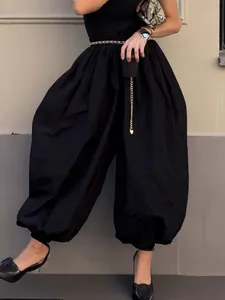 Elegant women's black high-waisted balloon trousers with cuffed hem for a modern urban look