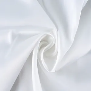 Close-up detail of high-quality white satin fabric texture for elegant camisole top