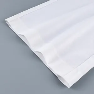 Close-up view of white wide-leg trousers showing fabric texture and hem stitching detail