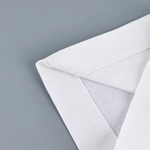 Macro view showing the high-quality hem stitching on white wide-leg trousers detail