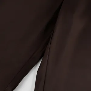 Macro detail of smooth dark brown satin fabric texture for straight-leg trousers