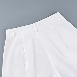 Detailed view of the waistband on these elegant white high-waisted wide-leg trousers