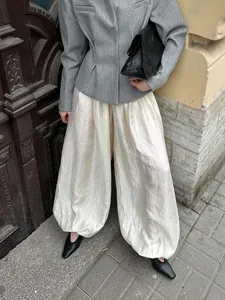 Detail showing textured cream satin balloon pants for an elegant casual streetwear look