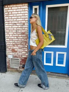 Fashionable white lace camisole top styled in a trendy street photography scene outdoors