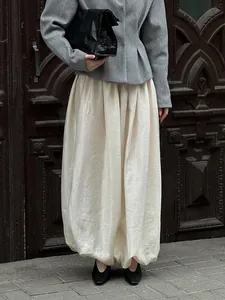 Elegant cream-colored loose lantern pants featuring a unique textured finish and elastic hem