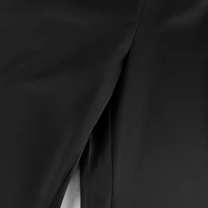 Detail showing the elegant slit and smooth satin texture on black acetate trousers