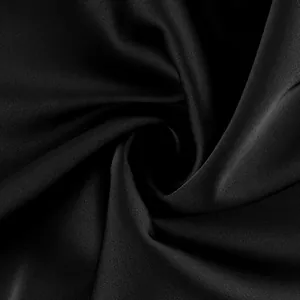 Detailed macro view of black acetate-like satin fabric texture with elegant smooth gloss