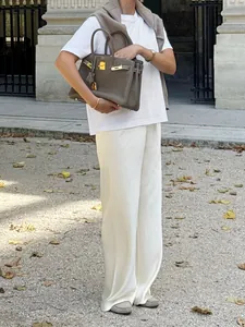 Elegant white wide-leg satin trousers featuring high waist and graceful drape for women.