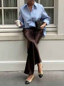 Fashionable dark brown high-waisted satin wide-leg pants with elegant drape for work
