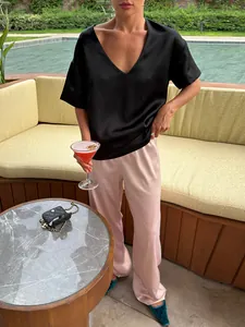 Elegant high-waisted satin straight-leg trousers in light pink for a chic summer outfit.