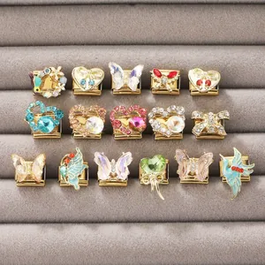 Détail de breloques de bracelet style italien avec motifs papillon et cœur en cristal
