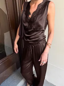 Close-up detail of a dark brown satin V-neck lace tank top and matching straight pants set