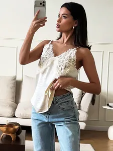 Elegant white lace V-neck camisole top for women paired with stylish light blue jeans