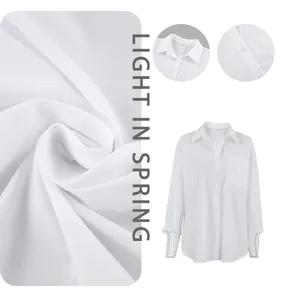 Detailed view of the lightweight fabric texture and collar on a white oversize button-down shirt