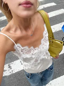 Stylish white lace patchwork satin camisole top for women shown in a casual street setting