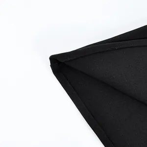 Detailopname van de zwarte stoftextuur en stiksels van een elegant kanten damesjack