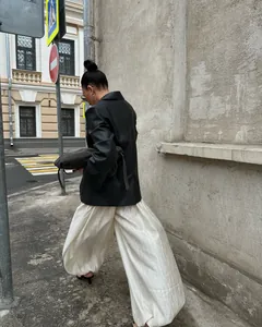 Stylish cream lantern pants with pleated texture for chic street style fashion.
