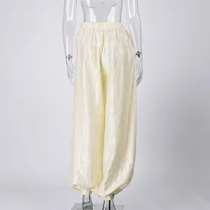 Back view of shimmery light yellow balloon pants showing elastic waist and cuffs