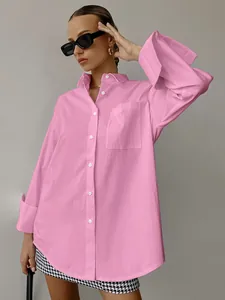 Detail of pink oversized boyfriend style shirt with front pocket and large cuffs