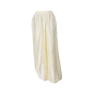 Elegant cream lantern pants featuring shiny crinkled fabric and elastic gathered cuffs