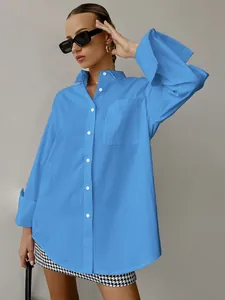 Detailed view of a bright blue oversized boyfriend style long sleeve shirt with pocket