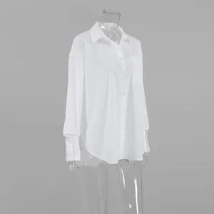 Detailed view of a minimalist white oversized boyfriend shirt with long sleeves.