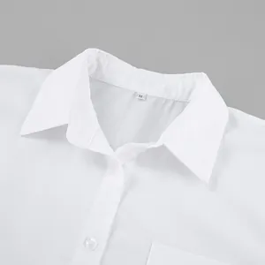 Close-up of classic white boyfriend-style shirt neckline with collar and buttons