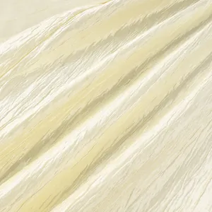 Detailed macro view of cream crushed textured fabric for lightweight summer lantern pants