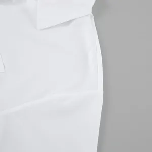 Detail of oversized white shirt showing fabric texture and side split seam design