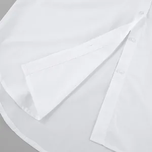 Detailed macro view of minimalist white oversized boyfriend shirt hem and buttons
