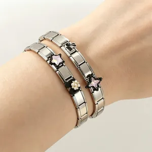 Macro detail of Italian modular charm bracelets with Kuromi style bunny and pink stars