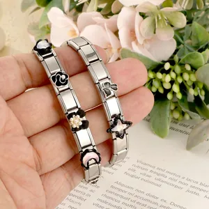Close-up of DIY stainless steel Italian charm bracelets with flower and rabbit elements